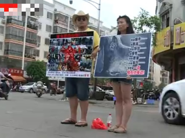 来自山西爱狗夫妇,在餐馆前举牌抗议吃狗肉行为。