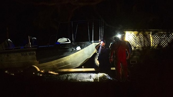 警方和野生鳄鱼管理部门工作人员对食人鳄鱼的尸体进行检查