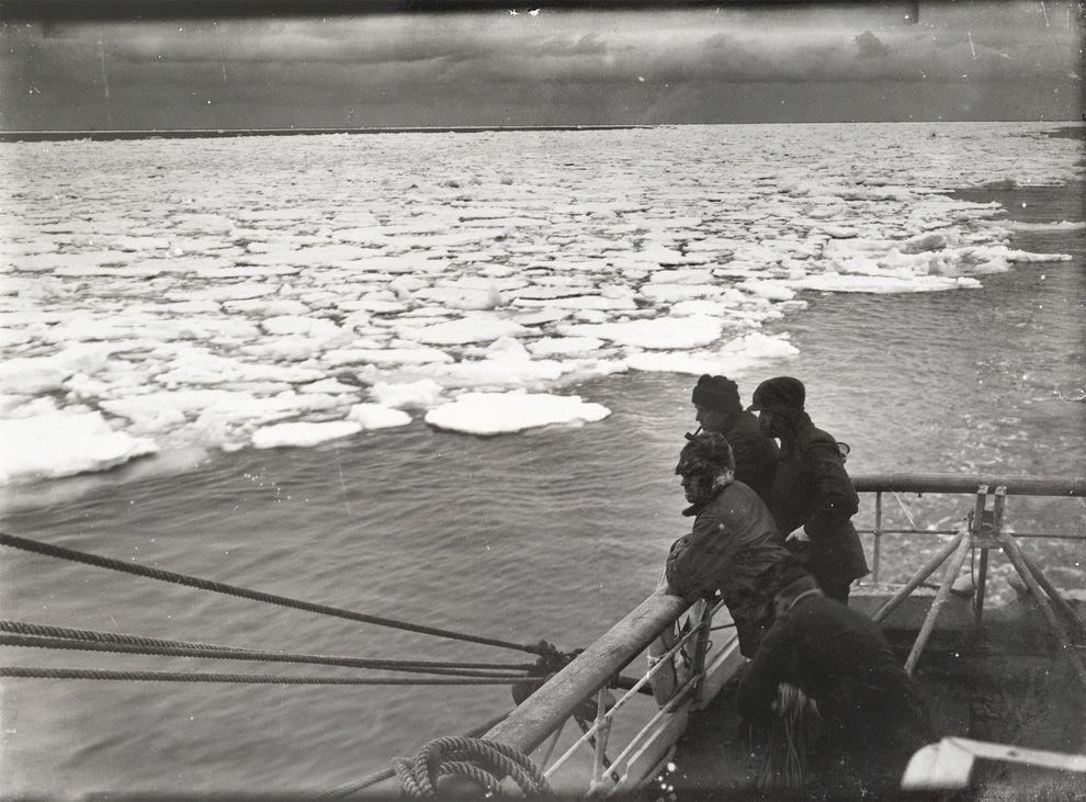 1910年12月,罗伯特・史考特率队前往南极探险时,船员在Terra Nova 号的甲板上看着荷叶冰。摄影:Herbert G. Ponting