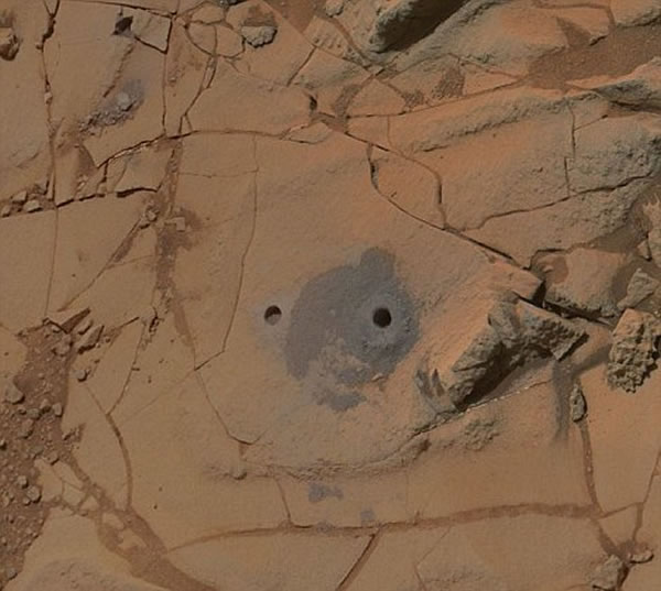 这些照片的细节极其清楚,我们可以看到两个由“好奇号”在莫哈维取样点钻出的取样孔。