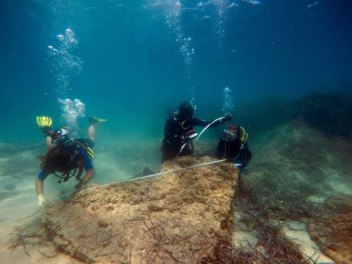 探险队为一件古迹做记录。