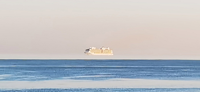 海市蜃楼“上蜃景”:英国男子在多塞特郡伯恩茅斯海岸拍到巨大邮轮飘浮在空中